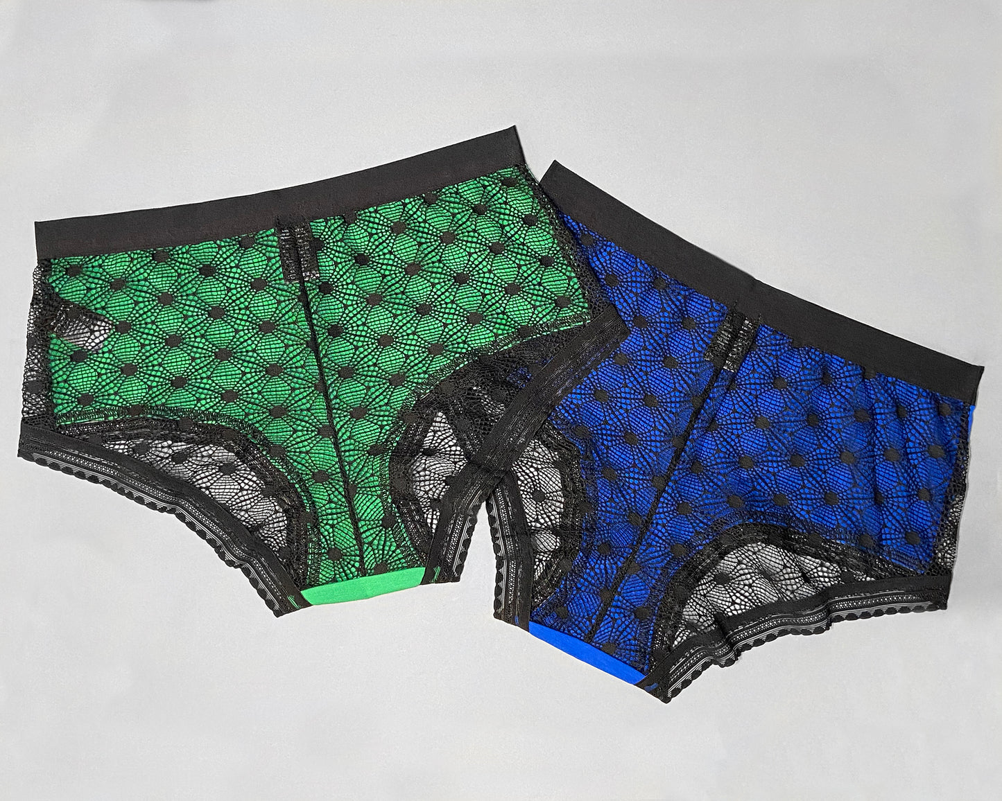 Back view of two samples of The Mix Hipster, in the green and blue colourway. You can see the colour of the fabric through the sheer lace geometric pattern. Both samples has the standard elastic in the legopening.